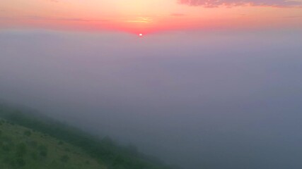Wall Mural - Bird's eye view of the fantastic ocean of clouds at sunrise. Cinematic aerial shot, drone flying. Location place of Dniester, Ukraine, Europe. Discover the beauty of earth. Filmed in 4k, Drone video.