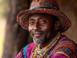 © Bussakon - Portrait of an adult man with a warm smile wearing a vibrantly colorful traditional beaded hat and intricate necklaces reflecting cultural heritage