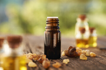 Wall Mural - A bottle of frankincense essential oil with frankincense crystals