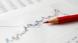 © Natti - Financial graph analyzing market stock data with a pen and paper.