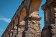 Closeup of a stone column from an aqueduct bridge blending into the background on a sunny day in Guadalajara Jalisco Mexico