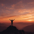 © Chau Tan - Man standing on mountain peak with arms raised at sunrise over scenic landscape
