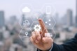 © The Little Hut - Smart Technology Integration: Hand Touching Interface with Cloud, Truck, and Communication Icons Over Cityscape