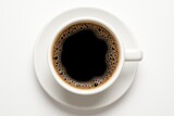 Bird's eye shot of a coffee cup on a plain white surface