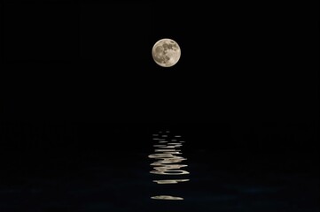 Wall Mural - nighttime view of the moon over a coastal town near a famous lagoon