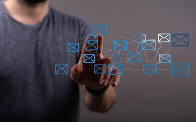 Abstract image of a person interacting with a digital network of email icons, representing communication and connectivity.