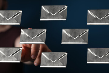 Person interacting with digital email envelopes, showing inbox management.