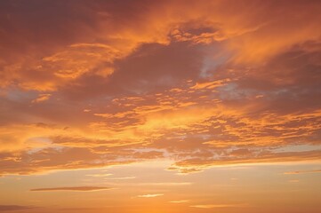Wall Mural - morning sky with vibrant orange and colorful clouds at sunrise