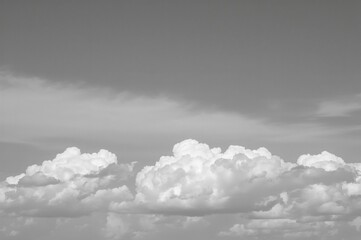 Wall Mural - Monochrome photo showing white clouds against the sky