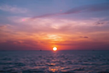 Wall Mural - evening sky with shades of blue, purple, and pink, soft clouds, golden and amber sunrise over water,