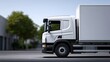 © pkproject - A large commercial delivery truck parked on a city street, with modern architecture and buildings in the background.