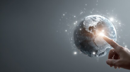 hand touching a virtual, glowing planet earth