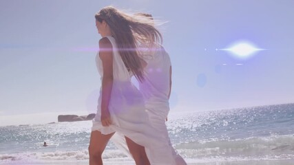 Wall Mural - animation of glowing light over woman with stretched arms relaxing in nature against blue sky