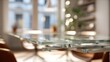 © Justlight - Adjustable glass dining table midextension highlighting sleek transparent surface while surroundings fade into soft bokeh.