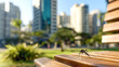 © Diana - Aedes albopictus mosquito resting on a wooden bench in a modern urban park with tall buildings and greenery in the background. Daylight setting. Represents vector-borne disease risk in populated areas
