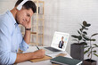 © New Africa - E-learning concept. Student having online video chat with teacher via laptop at desk