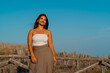 © Bohdan - Smiling Woman in White Top Against Blue Sky