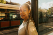 © Maskot - Sunlight shining on smiling beautiful young woman with braided hair