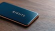 © FocusFusion - Mobile Device Displaying the Word Rights on a Wooden Surface