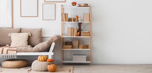 Poster - interior of light living room with autumn decor, sofa and blank frames