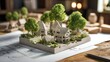 © Ramjan - Dreaming of eco friendly homes architectural model showcasing sustainable design with miniature trees in neighborhood setting blueprint details