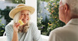 © Kobus L/peopleimages.com - Patio, old couple and break with fruit, home and conversation on weekend, wellness and healthy food. Outdoor, senior woman and elderly man with pineapple on date, romance or people with commitment