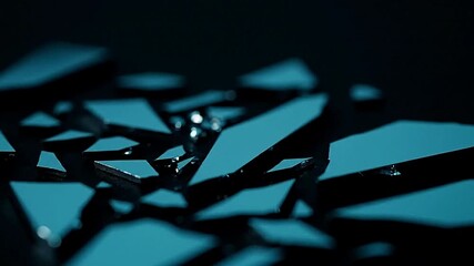 Turquoise angular shards gleam on a dark surface creating a fragmented pattern