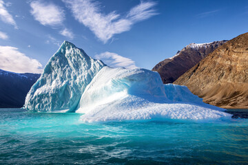 Wall Mural - giant blue iceberg in the turquoise waters of kjerulf fjord, northeast greenland national park. know
