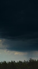 Wall Mural - Time Lapse Dramatic Sky With Heavy Rain Clouds Above Forest. Time-lapse Colorful Cloudy Dark Blue Sky Fluffy Clouds. Rain Above Forest Landscape. Rain Cloud Formation Timelapse. Dark Sky. Bad Weather