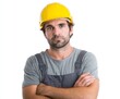 © mila - A worker in a grey uniform and bright yellow safety helmet, arms crossed, presents a serious and neutral expression against a plain white background.