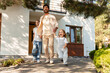 © Maria Vitkovska - Father leaving home with daughters, holding hands and smiling