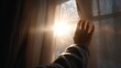 © Nu - Hand Reaching to Open Window Curtain to Let in Winter Sunlight and Warmth into a Room