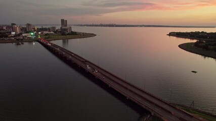 Wall Mural - Aerial footage of the Mboi Ca'e Bridge crossing Parana River, in southern Paraguay at sunset
