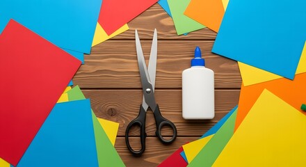 Creative arts and crafts background with scissors, glue, and vibrant colored paper sheets on a wooden desk for a DIY project