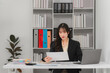 © Kritdanai - Asian Businesswoman Working at Office Desk