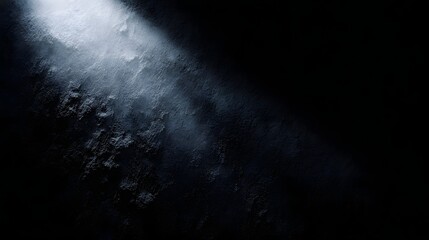 Wall Mural - dramatic spotlight illuminating a dark heavily textured grunge background creating strong contrast a