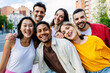 © Xavier Lorenzo - Diverse group of young people laughing at camera standing at city street. Portrait of happy multiracial students outdoors. Youth community concept.