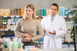 © JackF - Young woman feels cramps and pain during her menstrual period. European woman during PMS in the pharmacy against the background of a pharmacist
