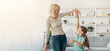 © Prostock-studio - Happy mature lady and casual little daughter dancing waltz at home, standing in living room, full length photo. Loving grandmother teaching granddaughter how to dance having fun together at home
