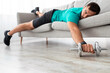 © Prostock-studio - Tired millennial male with beard lies on sofa with dumbbells rest after exercise in living room interior. Relax, take break and pause at training, body care, workout at home during covid-19 pandemic