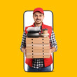 © New Africa - Food delivery service worker giving online order out of mobile phone display. Orange background