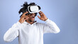 © Prostock-studio - Funky Afro teen guy wearing VR headset, exploring cyberspace, using virtual reality for entertainment on violet studio background. Cool black adolescent experiencing modern technologies