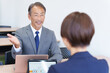 © polkadot - 会議するビジネスマンの上司部下