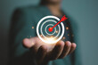 © ภัทรชัย รัตนชัยวงค์ - Business success and target achievement concept with red dart hitting bullseye, symbolizing goal setting, strategy, focus, precision, and successful project completion in marketing or career target
