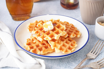 Wall Mural - Plate of tasty waffles with maple syrup on white background