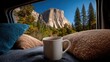 © Tin - Mountain scenery view from inside a campervan concept. A cozy mug on pillows with stunning mountain views outside.