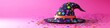 © Noman - Starry witch hat on pink background surrounded by colorful star confetti decor