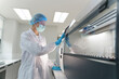 © FotoArtist - Laboratory technician operates advanced equipment during research process in modern facility
