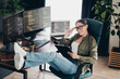 © deagreez - Charming female programmer working remotely with multiple monitors in a stylish home office