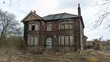 © MikeBeverley - Abandoned ghost story hoax home. Derelict empty 'Haunted Murder House' Heskin, Lancashire. Brick building boarded up bay windows, desolate overgrown garden. Decaying creepy neglected property exterior
